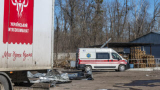 Автомобіль швидкої допомоги поруч із завалами пошкодженої будівлі підприємства після атаки російського безпілотника на м'ясокомбінат у Харкові, 11 березня 2026 року